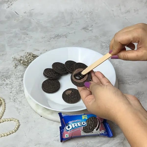 Chocolate-Covered Oreo Pops - Twisting Oreos Apart