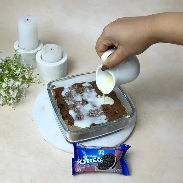 Chocolate Oreo Poke Cake - Pouring Condensed Milk