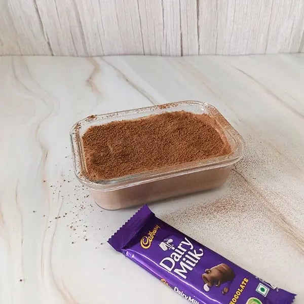 Chocolate Rice Pudding Mousse with Almond Crunch - Dust the top with cocoa powder