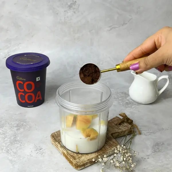 Cocoa Chikoo Smoothie - Adding Cocoa Powder