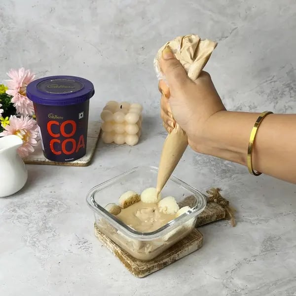 Cocoa Flavored Rasgulla Tiramisu - Dusting Cocoa Powder