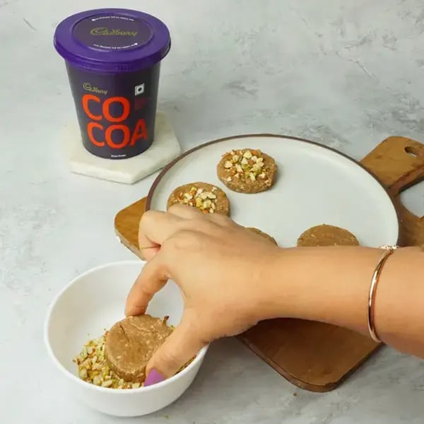 Cocoa Sandesh With Nuts - Garnish each Sandesh