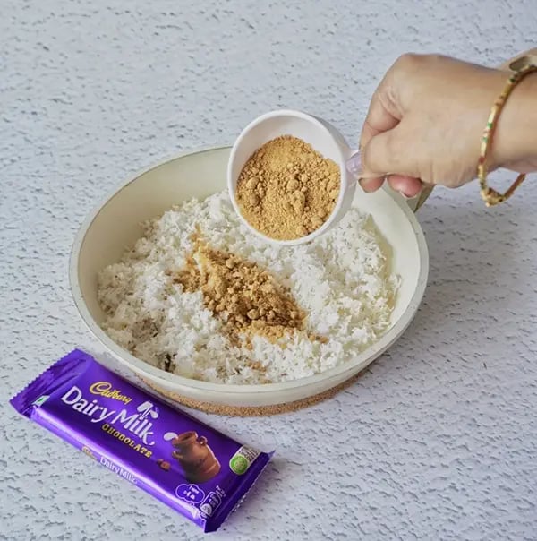 Coconut Laddoo With Dairy Milk And Jaggery-Add jaggery powder