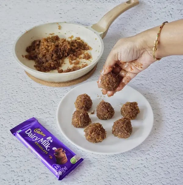 Coconut Laddoo With Dairy Milk And Jaggery-Take a spoonful of the mixture