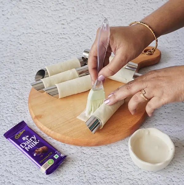 Crispy Rolls with Coconut and Dairy Milk Chocolate- Seal the edge with a maida