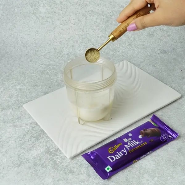Dairy Milk Almond Peda-Add cardamom powder to the jar