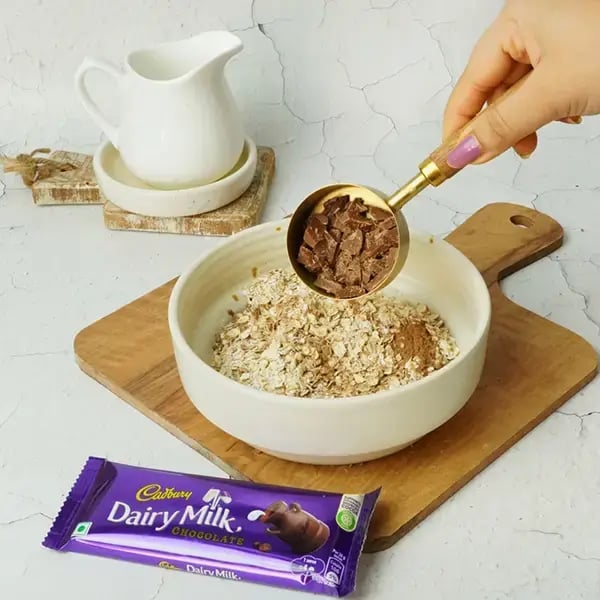 Dairy Milk Chilli Oats Cookies - Transfer chopped chocolates in an oats bowl