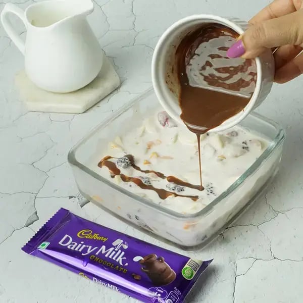 Dairy Milk Choco Fruit Cream Dessert - Pour the melted Dairy Milk mixture