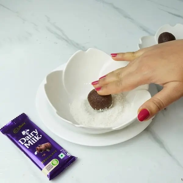Dairy Milk Chocolate Almond Laddu - Desiccated coconut and coat the laddus