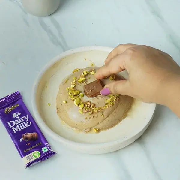 Dairy Milk Chocolate Bhapa Doi - Garnish it with some chopped pistachios