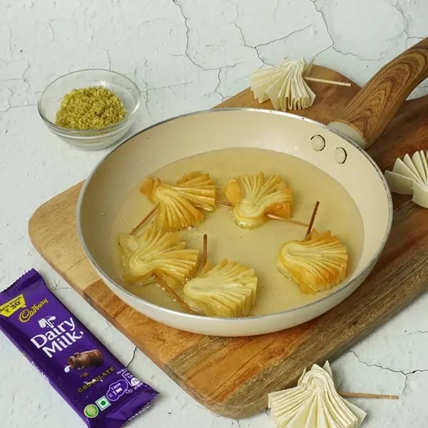 Dairy Milk Coated Baklava Fan Sweet-Heat the oil in a medium-sized pan
