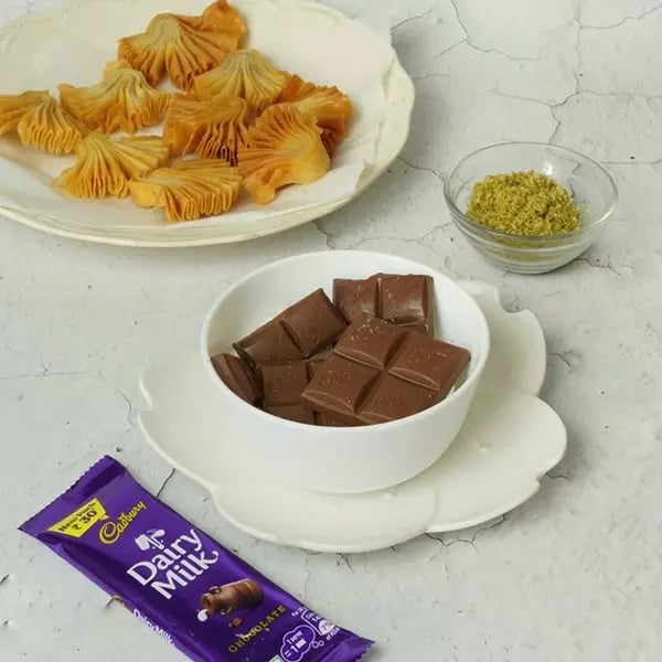 Dairy Milk Coated Baklava Fan Sweet-Take a bowl carefully break the Cadbury Dairy Milk chocolates
