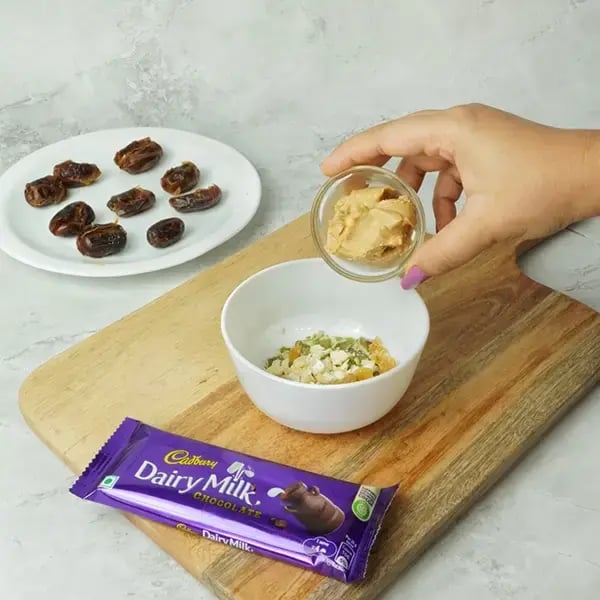 Dairy Milk Coated Peanut Butter Stuffed Dates - Combine the chopped nuts and peanut butter
