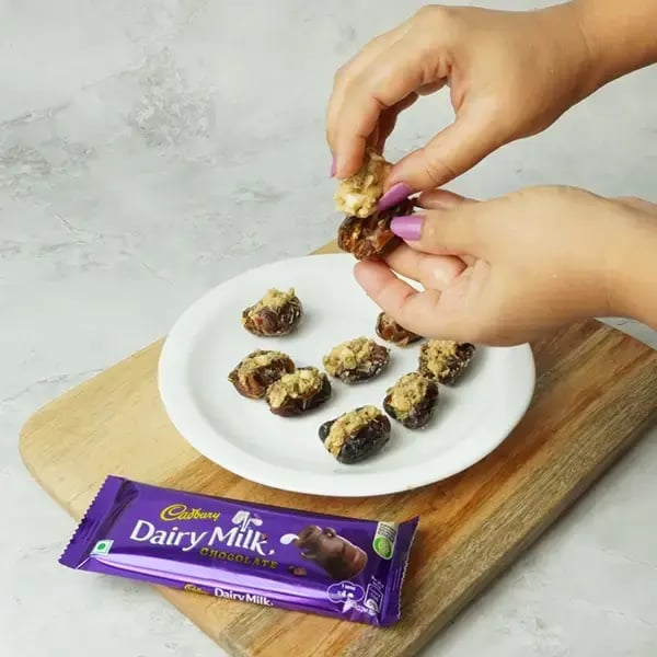 Dairy Milk Coated Peanut Butter Stuffed Dates -  Stuff the peanut butter and nut mixture