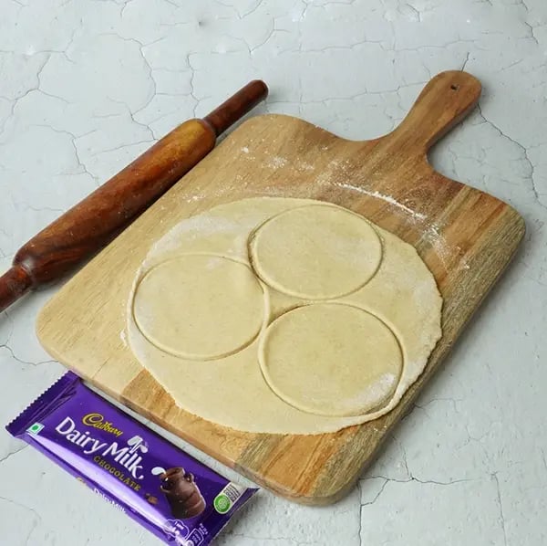 Dairy Milk Coconut Karanji-With a rolling pin