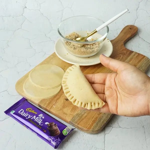 Dairy Milk Coconut Karanji-Apply water all over the outer edge