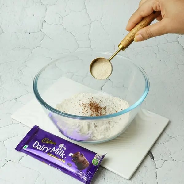 Dairy Milk Covered Cinnamon Loukoumades-In a large bowl