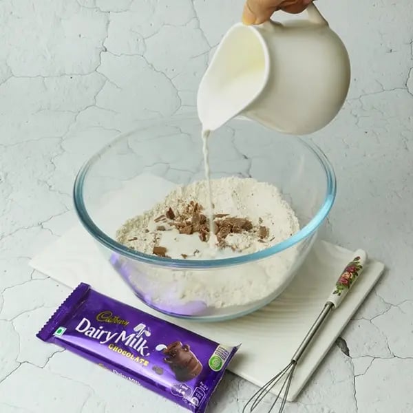 Dairy Milk Covered Cinnamon Loukoumades-Pour warm milk