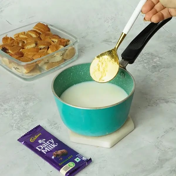 Dairy Milk Covered Croissant Pudding - Mix milk and custard powder in a pan