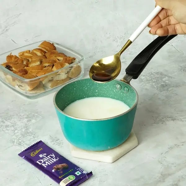 Dairy Milk Covered Croissant Pudding - Add vanilla essence into the same pan