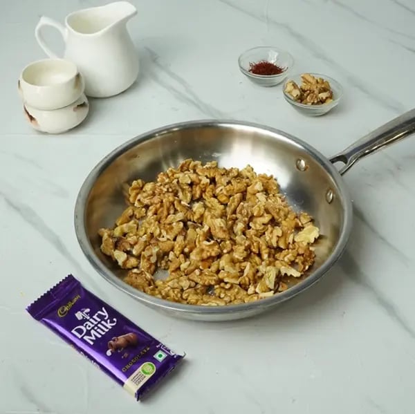 Dairy Milk Drizzle Walnut Kesar Barfi -Start by shallow frying the walnuts