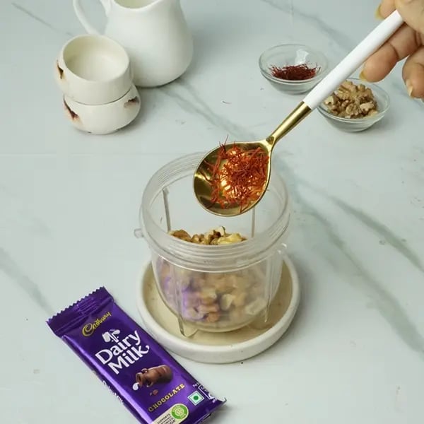 Dairy Milk Drizzle Walnut Kesar Barfi - Once walnuts cool transfer it to a blender