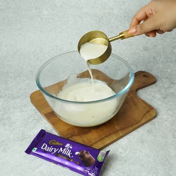 Dairy Milk Eggless Cake with Cocoa-Now add milk into the same bowl