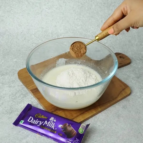 Dairy Milk Eggless Cake with Cocoa-Add cocoa powder