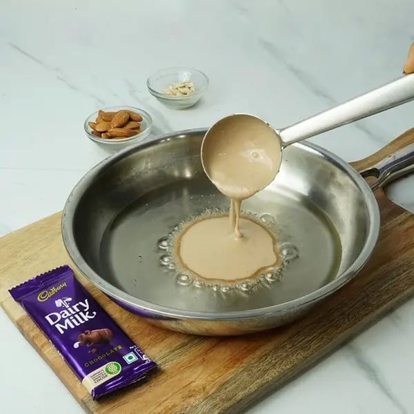 Dairy Milk Malpua with Cashew and Almonds - Pour batter pancake shape