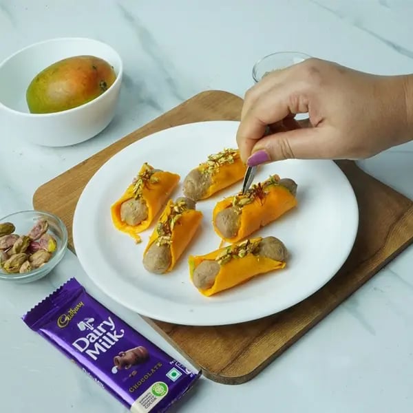 Dairy Milk Mango Sandesh Roll-Garnish with chopped pistachios