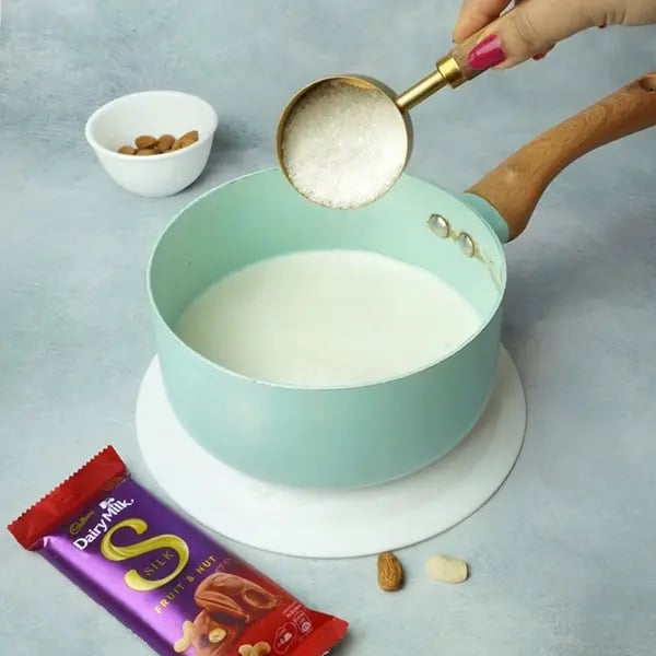Dairy Milk Silk Chocolate Pudding with Cashew Almonds Garnish - Boil milk and sugar