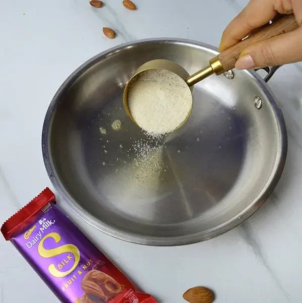 Dairy Milk Silk Rich and Creamy Badam Halwa - Heat a pan and add ghee