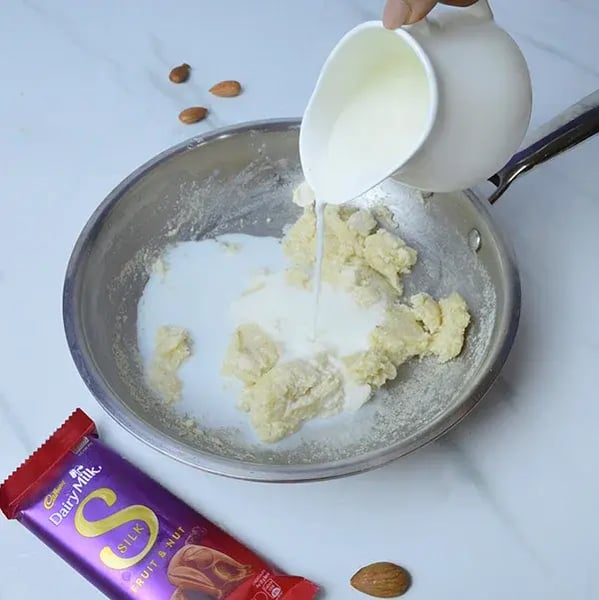 Rich & Creamy Chocolate Badam Halwa Recipe - Milk Being Poured