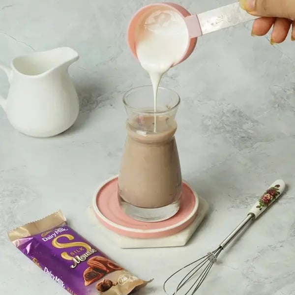 Dairy Milk Silk Tres Leches Cake-Pour the cream next and mix it