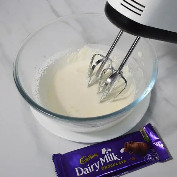 Dairy Milk Thandai Mousse With Cashew Crunch - Whip with an electric hand beater