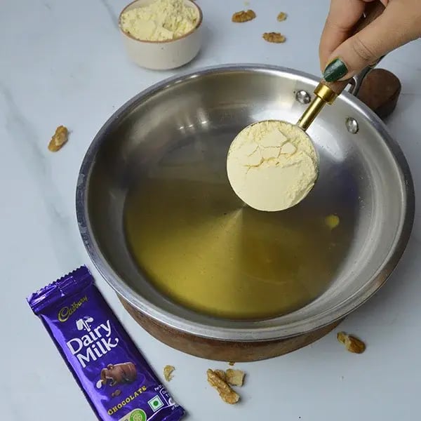 Dairy Milk Walnuts Infused Besan Barfi - Heat a pan