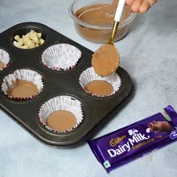 Dairymilk Chocolate Cashew Buttercups - Pour melted Chocolate