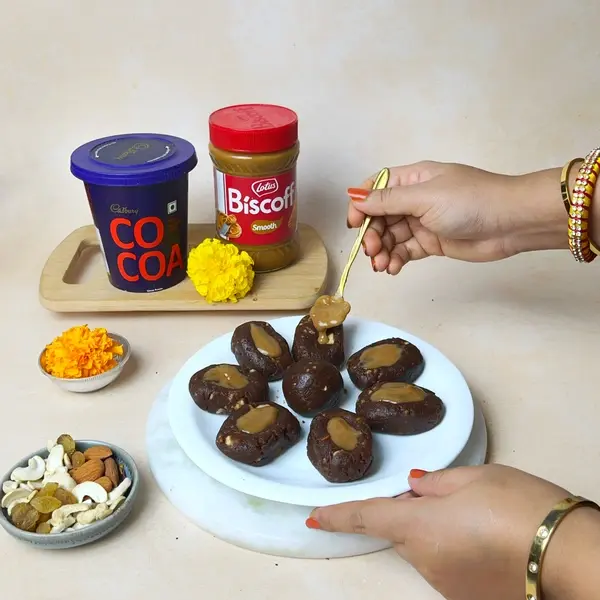Diwali Special Pinni Recipe With Biscoff And Cadbury Cocoa Powder - Garnished Pinni With Spread