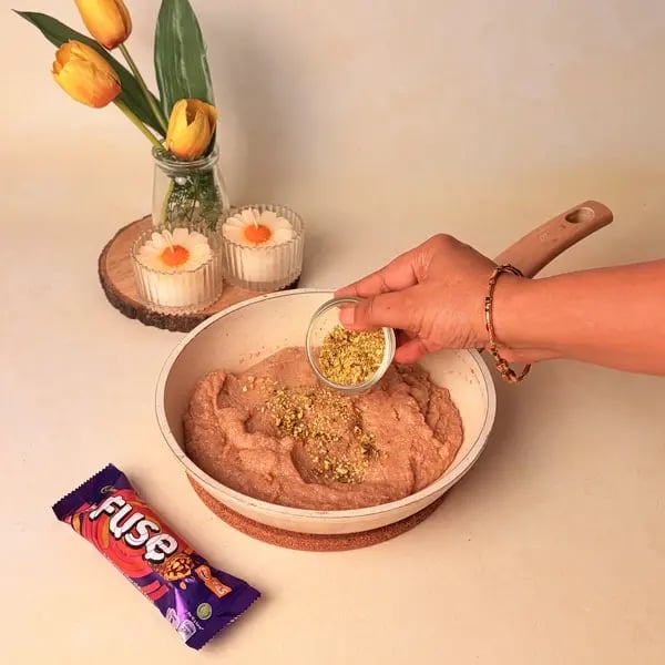 Easy Festive Special Rava Laddu With Cadbury Fuse To Celebrate Navratri - Mixing Pistachios In Laddu