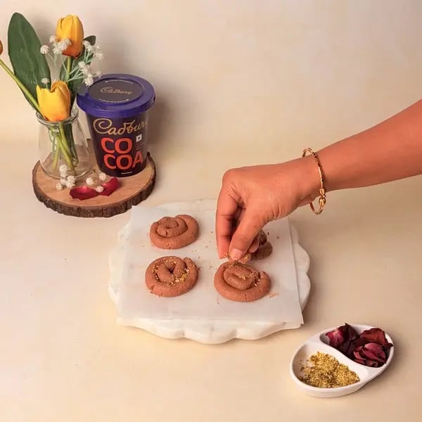 Festive Special Chocolate Mawa Jalebi Recipe With Cadbury Cocoa Powder, Rose And Pistachio Topping - Sprinkling Pistachios Rose Petals