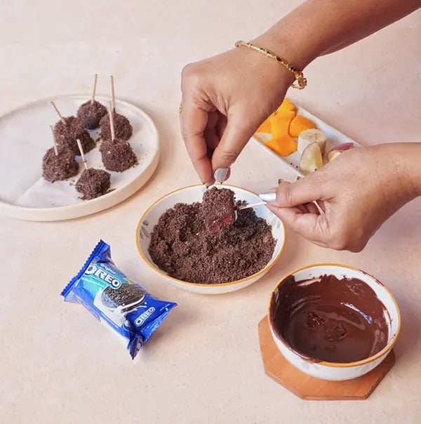 Frozen Bournville Chocolate Fruit Bites with Oreo Dust-Immediately roll or sprinkle the chocolate-coated