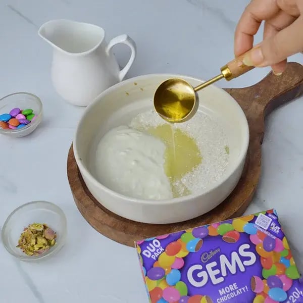 Gems Topping Pistachio Infused Chocolate Cupcakes - Mix curd, sugar, and oil