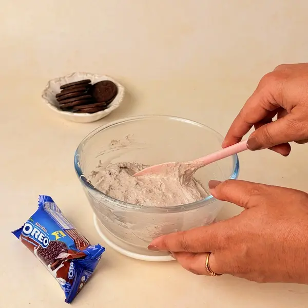 Halloween-Themed Cheesecake - An Oreo-Crusted Black Cocoa Dessert - Folding Oreo Crumbs