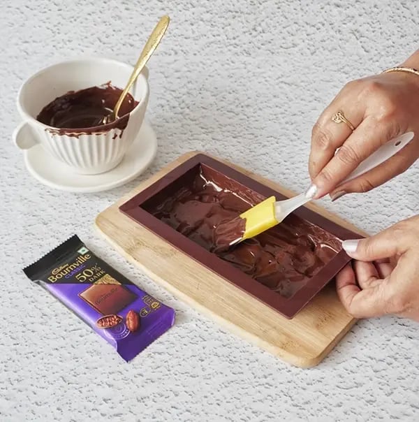 Healthy & Chocolatey Fruit Salad Bars with Bournville Chocolate - Pour a layer of the melted chocolate into a chocolate bar mould