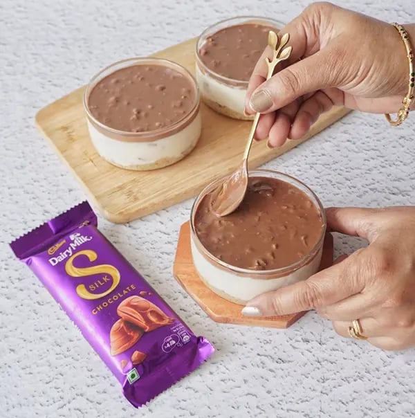 Healthy Cheesecake with Dairy Milk Silk and Mixed Nuts - Pour the melted chocolate-nut mixture over the cheesecake layer