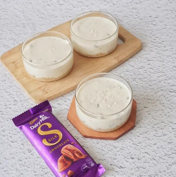 Healthy Cheesecake with Dairy Milk Silk and Mixed Nuts - Pour the cheesecake mixture over the set nut base