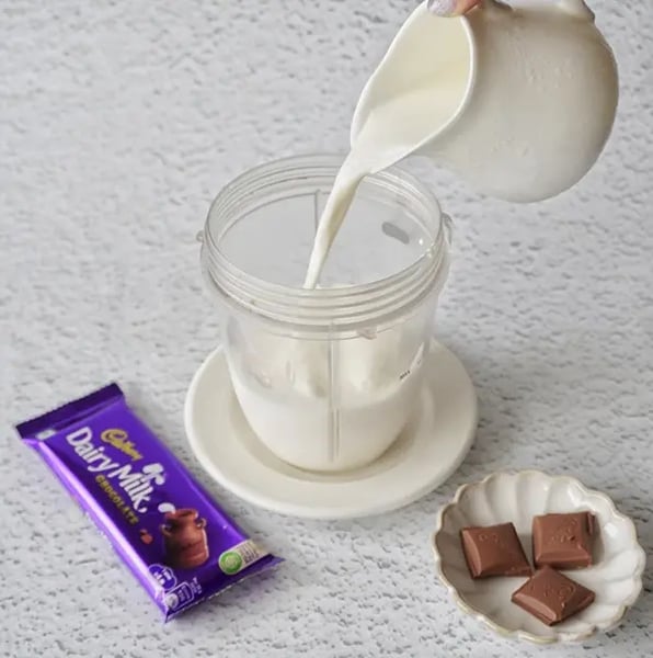 Iced Chocolate Shake With Cadbury Dairy Milk Chocolate Recipe - Pouring Milk