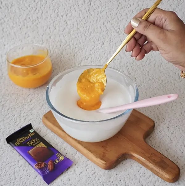 Mango Mousse with Dark Chocolate Crunch - Gradually add the mango puree