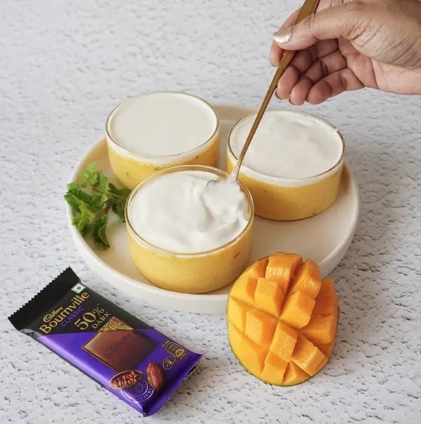 Mango Mousse with Dark Chocolate Crunch - Garnishing with whipped cream
