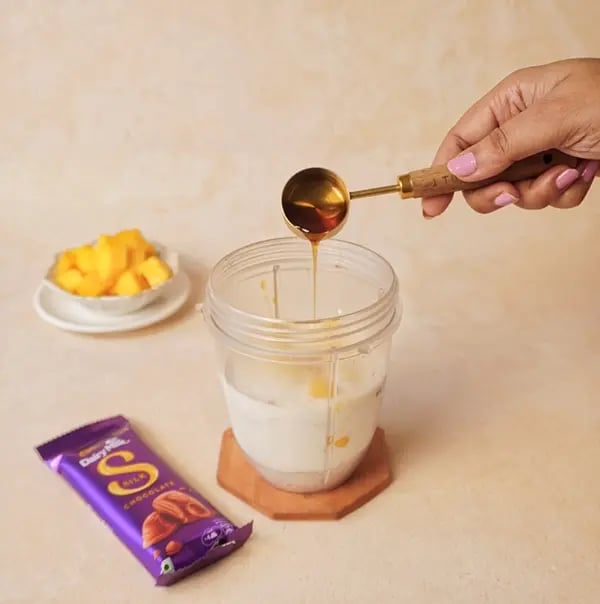 Mango Oats Smoothie with Cadbury Silk Crunch-Drizzle in golden honey